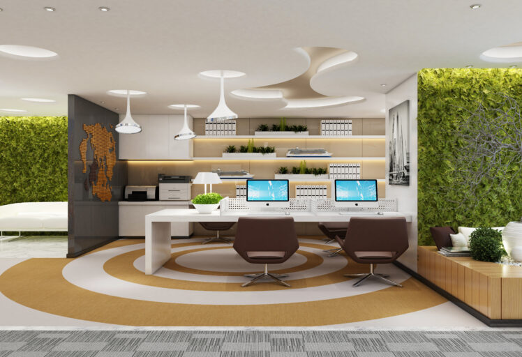 Modern office with green walls, circular rugs, sleek desks, and iMac computers on workstations.