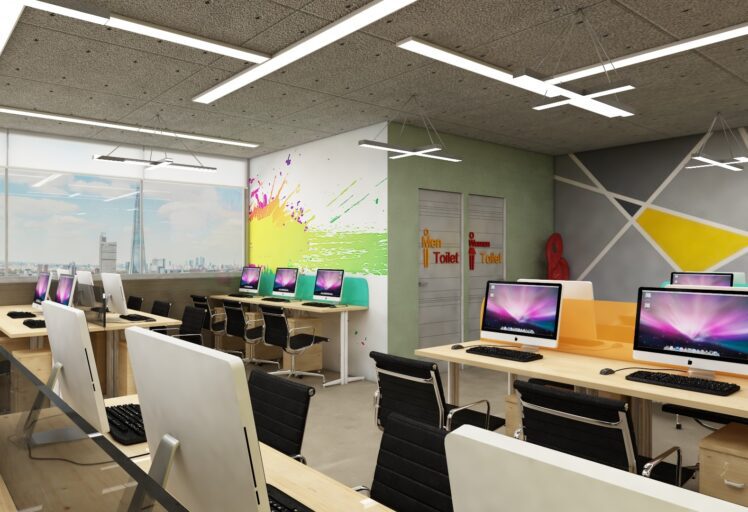 Modern office interior design with vibrant walls, sleek desks, and stylish computer setups.