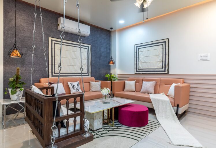 Contemporary living room interior design with peach sofas, wooden swing, and accent lighting.