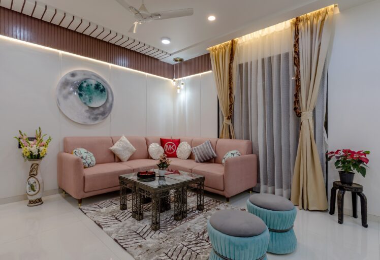 Modern living room interior design with pastel sofa, artistic wall decor, and elegant curtains.