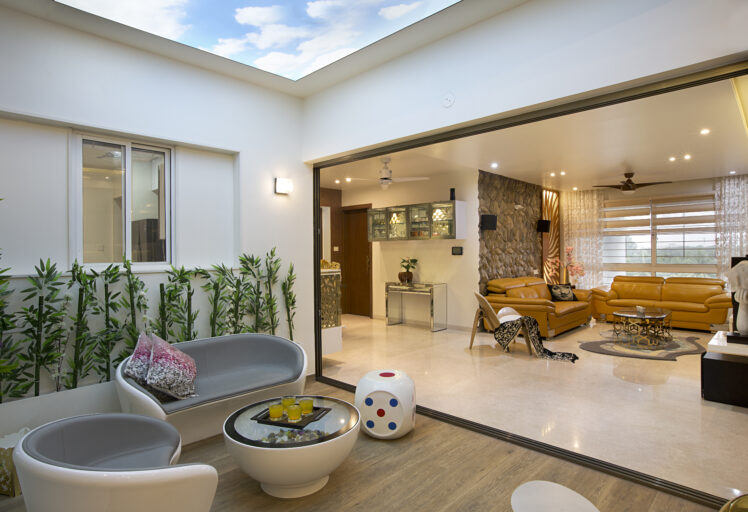 Stylish interior design featuring a skylit patio and a cozy living room with modern furniture.